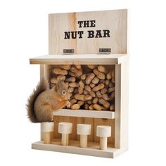 the nut bar is made out of wood and has a squirrel in it's mouth