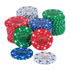 four poker chips with the words lucky on them in different colors and sizes, all stacked up