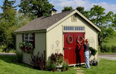 two people standing in front of a shed