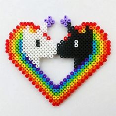 a couple of animals that are in the shape of a heart with some beads on it