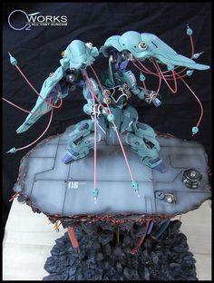 a robot that is sitting on top of a piece of paper with wires coming out of it