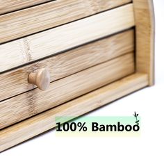 a close up of a wooden drawer with the words bamboo on it and an arrow