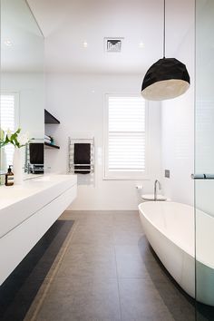 a bathroom with a large bathtub next to a sink