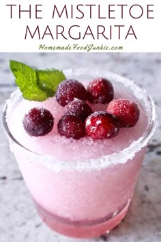 the mistletoe margarita with raspberries and mint garnish on top