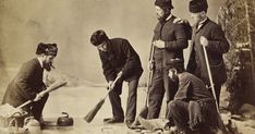 an old black and white photo of men working in the snow with their shovels