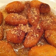 some fried food is in a bowl with sauce and bread crumbs on top