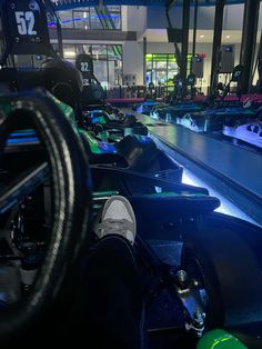 the interior of a gym with rows of treads and exercise equipment on display at night