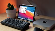 an apple computer sitting on top of a wooden desk next to a keyboard and mouse