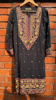 This is a one of a kind piece in size S only. Perfect for a mehendi/haldi/dholki, or a girl's night out. The delicate pink floral embroidery gives it a beautiful feminine look.  1Piece .  Dry clean only, with medium iron NO RETURNS. Semi-stitched Black Art Silk Blouse Piece, Bohemian Semi-stitched Raw Silk Traditional Wear, Party Traditional Wear With Dabka On Cotton Silk, Party Traditional Wear In Cotton Silk With Dabka, Festive Traditional Raw Silk Lawn Suit, Festive Jamawar Embroidered Fabric With Dabka, Black Semi-stitched Embroidered Fabric, Festival Lawn Suit With Resham Embroidery In Raw Silk, Festive Raw Silk Lawn Suit With Resham Embroidery