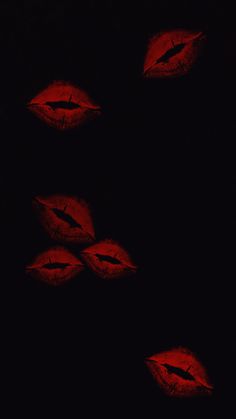 four red lips are shown in the dark