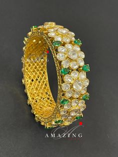 Silver Moissanite Polki Bangles | Polki Bangles | Indian Traditional Bangles | Indian Polki Bangles | Moissanite Bangles | Openable Bangles Material : Silver Gemstone: Moissanite Stone colour: Uncut polki, Hydro Emerald Primary colour: Gold Bangle : Openable Bangle Silver Intricate, hand crafted, Pure Silver Moissanite Polki Bangles, studded with high quality uncut moissanite polki Bangles , made in 92.5 silver with 22ct gold plating. Product comes with 92.5 silver hallmark. Bangles are Openable Cutdana Bangle Jewelry For Reception, Fusion Style Wedding Bracelets With Cutdana, Cutdana Bangle For Receptions, Fusion Style Cutdana Bracelets For Wedding, Cutdana Bangle For Reception, Luxury Gemstone Cuff Bracelet For Weddings, Elegant Gemstone Cuff Bracelet For Wedding, Elegant Cuff Bracelet For Wedding And Festive Occasions, Fusion Style Wedding Cuff Bracelet With Intricate Design