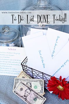 money and cards are sitting in a glass jar on a blue cloth with a red flower