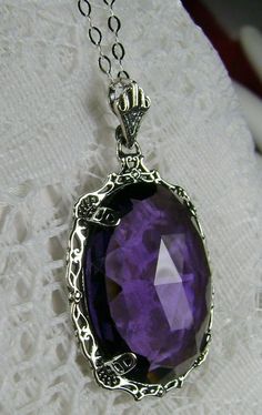 "Simulated Purple Amethyst Pendant Bubble Design#P10 Custom Made Inspired by Victorian era designs, I now offer this lovely Antique reproduction in sterling silver. The flawless 22ct faceted Simulated/man-made purple amethyst is 24mm long (15/16th\") and 18mm in width (3/4th\"). The entire pendant is 1.5\" long and 7/8\" wide. The chain (if chosen) is between 16-18\" in length and is marked 925 as well. Notice the beautiful craftsmanship of the Victorian filigree setting. This pendant necklace i Purple Gothic Jewelry For Formal Occasions, Gothic Purple Jewelry For Formal Occasions, Purple Pendant Necklace, Victorian Filigree, Filigree Pendant Necklace, Pretty Jewelry Necklaces, Filigree Pendant, Antique Necklace, Filigree Design