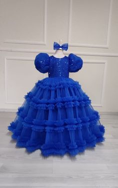 Celebrate in style with our Royal Blue Flower Girl Ball Gown! This exquisite dress is perfect for any special occasion, whether it's a wedding, birthday party, or princess-themed event. Made with attention to detail and a touch of magic, this baby blue princess dress will make your little one feel like royalty. The special design features a puffy tutu skirt that adds volume and flair, creating a truly enchanting look. Crafted with care and made for comfort, this dress is sure to be a hit with both parents and princesses alike. Order now and let your little one shine bright like a star. Kids Ball Gowns Princesses, Blue Tulle Dress For Party, Blue Tulle Party Dress, Fitted Blue Ball Gown For Party, Elegant Blue Birthday Dress, Elegant Blue Dress For Birthday, Blue Princess Gown For Party, Blue Princess Style Party Dress, Blue Princess Style Party Gown