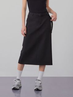 This product is a belted long skirt that exudes sophistication and modern style. The high-waisted design is accentuated with a belt, offering both elegance and a flattering fit. - The skirt features a sleek, straight cut that falls to mid-calf, providing a streamlined silhouette.- A built-in belt cinches at the waist, enhancing the skirt’s tailored appearance.- Made from a smooth, structured fabric, the skirt holds its shape while allowing for ease of movement.- Perfect for professional settings or dressy occasions, this skirt pairs effortlessly with both fitted and loose tops. Structured Fabric, Loose Tops, Straight Cut, Long Skirt, Mid Calf, Modern Style, Built In, Sleek, High Waisted