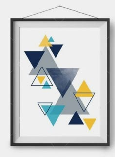 an art print with triangles on it hanging from a wall above a white floor and black frame