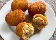 four fried food items on a white plate