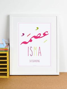 a framed poster with the word isma written in pink, green, and yellow