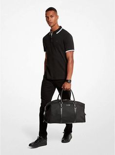 Our Brooklyn duffel bag is crafted from a durable recycled nylon reinforced with smooth faux leather trim. The spacious interior will easily fit everything you need for an overnight trip, and the convertible design allows you to carry it over the shoulder or by hand. A decorative chain link strap adds a distinctive finish..• Duffel bag.• Recycled nylon.• 100% recycled nylon.• Trim 1: 100% polyurethane.• Trim 2: 60% polyurethane/20% cotton/20% polyester.• Silver-tone hardware.• 22'W X 11'H X 10.5 Casual Black Travel Bag With Leather Trim, Functional On-the-go Luggage With Leather Trim, Classic Nylon Travel Bag For On-the-go, Classic Nylon Travel Bag With Luggage Sleeve, Casual Black Weekender Bag With Leather Trim, Nylon Travel Bag With Leather Trim, Nylon Luggage With Top Carry Handle For Overnight Trips, Overnight Nylon Luggage With Top Carry Handle, Casual Nylon Luggage For Weekend Trips