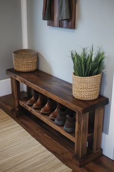 a wooden bench sitting next to a wall with shoes on top of it and a potted plant