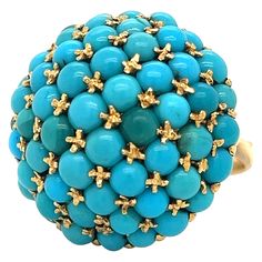 Amazing design crafted in 18k yellow gold. The ring highlights turquoise gemstones, cabochon cut and set in raised curved design also known as "bombe". This ring has a vintage charm as the turquoise compliments the yellow gold perfectly. Turquoise comes in a variety of colors, from light blue to dark green and this ring shows a nice color variety as multiple shades of the gemstone are seen. The ring is a size 8 and weighs 17.2 grams. The ring is fully sizable to your specifications. This ring although simple, is truly a show stopper. The ring is large and will fill the finger beautifully. The dome portion of the ring measures 1" in circumference. The ring is hallmarked 750 with a makers mark. The ring is in excellent pre owned condition, all photos taken under magnification. Bid confidentl Marc Fisher, The Ring, Gold Jewelry Fashion, Turquoise Gemstone, Cocktail Ring, Turquoise Jewelry, Cocktail Rings, Rings Statement, Vintage Charms