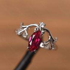 It is a ruby ring. The main stone is 5 mm* 10 mm marquise cut. weight about 1.34 carats. The basic metal is sterling silver and plated with rhodium. To change the metal to a solid gold (white/rose) or platinum is also available, please ask for a quotation if you want. You can also go to my shop Home for more elegant rings: https://www.etsy.com/shop/godjewelry?ref=hdr_shop_menu Alexandrite is June birthstone More alexandrite rings: https://www.etsy.com/shop/godjewelry?ref=seller-platform-mcnav&se Silver Marquise Ruby Ring For Anniversary, Silver Marquise Cut Ruby Promise Ring, Ruby Jewelry With Marquise Cut For Gifts, Silver Marquise Jewelry With Accent Stones, Silver Marquise Cut Jewelry With Accent Stones, Silver Jewelry With Marquise Cut Accent Stones, Elegant Silver Ruby Ring With Marquise Cut, Red Marquise Fine Jewelry, Silver Promise Ring With Lab-created Ruby