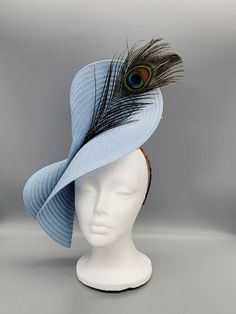 An elegant blue fascinator with a peacock feather accent.  Attached to a thin headband for ease of use.   This stunning handmade hat would be perfect for horse races, the Kentucky Derby, Melbourne Cup, Easter, weddings (Bridal Hat or Mother-of-the-Bride/Groom), church, christening, tea parties, cocktail parties, birthdays, bridal showers, engagement parties, bachelorette parties, baby showers, Mother's Day or just because you're ready to slay. If you're interested in having Rose + Ivy design a custom hat for your occasion, please send us a message and include your desired color or a photo of the outfit you are looking to match.  We will respond with options on styles, flowers, greenery, feathers, etc. to give you the hat of your dreams! Blush Pink Fascinator, Kentucky Derby Horses, Wedding Tea Party, Green Fascinator, Kentucky Derby Fascinator, Blue Fascinator, Royal Ascot Hats, Derby Horse, Derby Hats Fascinators