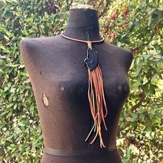 -This gorgeous bohemian necklace has a unique agate stone hanging from a leather-wrapped collar.  -Deerskin leather tassel contains vintage brass chains, and drapes 11" down the chest.-The collar is adjustable from 15" - 17" including a 2" adjuster chain.  Longer adjuster chains available by request.-Diameter of collar is about 5.5".-Each agate stone is unique, but approximate size is 3" x 1.5".-Designed and handmade in South Pasadena, CA.-Model shown also wearing our leather cuffs and leather w Artisan Tassel Necklaces For Festivals, Artisan Lariat Necklace For Festivals, Bohemian Black Hand Knotted Jewelry, Unique Lariat Necklace For Festivals, Rustic Adjustable Leather Necklace, Adjustable Rustic Leather Necklace, Bohemian Fringe Choker Jewelry, Bohemian Fringe Choker Necklace, Artisan Hand-knotted Jewelry For Festivals