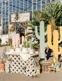 several cactus decorations are on display in a greenhouse