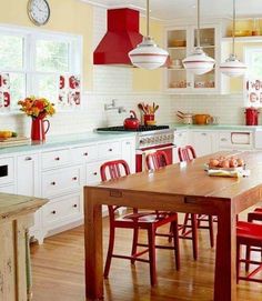 a kitchen filled with lots of red chairs next to a wooden table and counter top