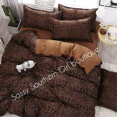 a leopard print comforter set on a bed