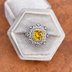 Estate 18KT white gold cut-corners yellow diamond + pave white diamond ring. Features a split shank with diamonds half way down. Pave, round diamonds center the modified yellow fancy, faceted, cushion diamond. Interesting undercarriage with scalloped diamonds. This an absolutely lovely attention getting piece with lots of intricate design. Size 6.25 Can be resized for an additional fee 1.64 CT Fancy Yellow Diamond Set in yellow gold, with prong set halo diamonds Then cluster of diamonds set in w Yellow Diamond Ring With Pave Setting For Anniversary, Yellow Diamond Ring For Anniversary, Dazzling Yellow Diamond Ring With Accents, Yellow Platinum Diamond Wedding Ring, Luxury Yellow Diamond Ring, Yellow Diamond Ring With Pave Setting For Wedding, Yellow Diamond Ring With Center Stone, Dazzling Yellow Diamond Ring With Center Stone, Elegant Yellow Diamond Ring With Brilliant Cut