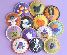 a pile of halloween buttons on a purple background