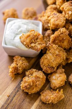 fried food on a cutting board with dip