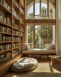 a living room filled with lots of books on top of a wooden shelf next to a window