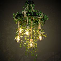 a chandelier with lights hanging from it's sides and ivy growing on top