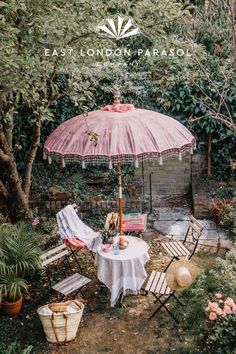 an outdoor table and chairs are set up in the garden for a tea party or brunch