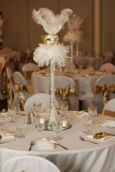 the centerpiece is decorated with white feathers