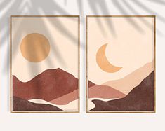 two paintings with mountains in the background and a sun setting behind them, on a white wall