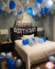 a bedroom decorated for a birthday with balloons and streamers