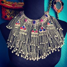 Large, base metal Kuchi necklace/choker with chains, glass stones & bells. This piece is in excellent vintage condition. The country of origin is Pakistan. All parts are intact & in great shape. There are 2 small loops on the back for you to thread a ribbon or cord through as a closure. A fantastic vintage piece in a most unusual color way. ❤️ Afghani Jewelry, Ash Hair, Ash Hair Color, Afghan Girl, Jewelry Holders, Afghan Fashion, Unique Keychains, Afghan Dresses, Colorful Earrings