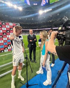 the soccer player is being interviewed by reporters