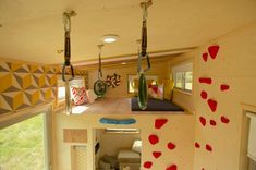 the interior of a tiny home with climbing walls