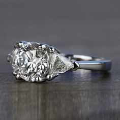 an engagement ring with three pear shaped diamonds