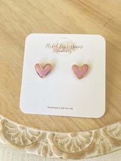 Beautiful Pink heart earrings are framed in gold metal hearts and finished with resin to make them shine.  They go with everything! Dress them up for a night out or wear them with your everyday outfits All earrings are handmade so no two are exactly the same. They all have their own thumbprint. Depending on the pattern/design/color scheme earrings may be slightly different than pictured.  - Hand Assembled - lightweight and gentle on the ear - surgical steel posts CARE * Colors may differ slightl Valentines Day Earrings, Metal Hearts, Pink Heart Earrings, Heart Valentines, Metal Heart, Earrings Pink, Pink Earrings, Heart Studs, Gold Heart