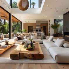 a living room filled with furniture and large windows