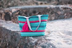 This item is in stock and ready to be shipped. Furthermore, it can also be picked up locally in Magnolia, TX. If you spend more than $99, the shipping costs will be covered by me! Get summer ready with the Mojito Beach Tote featuring a removable pink tassel, canvas material, zipper closure, two open interior pockets, and a Jess Lea label. Every bag is unique and colors may vary. -Canvas, 100% Cotton -Spot Clean -Shoulder Straps -Measurements: 12.5" x 19.5" x 5.5" Weight: 15.5oz Casual Pink Beach Bag For Poolside, Casual Pink Poolside Bag, Summer Pink Bags For Poolside, Green Summer Beach Bag For Poolside, Beach Season Tassel Beach Bag, Pink Bags With Tassels For Daily Use, Summer Beach Bag With Tassels For Travel, Multicolor Beach Bag With Tassels, Blue Summer Bag With Tassels