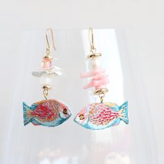 These tropical fish earrings look unique, they are full handmade and embroidered. There is used rhinestone Swarovski beads, natural pearl, glass and coral beads. Cute earrings can be a great gift for ocean lovers.  The earrings are super lightweight and comfortable for full day wearing. Pink and blue fish looks perfectly with a lot of outfits.  Embroidered jewelry is always about unique design and individuality.  I often get the feedback that the photo doesn't show how they are gorgeous, because Handmade Ocean-inspired Pearl Earrings For Gift, Coral Beaded Earrings For Gifts, Fish Earrings, Embroidered Jewelry, Beads Embroidery, Swarovski Beads, Blue Fish, Pink Paper, Natural Pearl