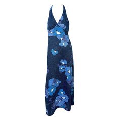 Presenting a dazzling blue floral Paco Rabanne halterneck gown from the 1970s. This luminous lurex gown boasts a metallic blue floral pattern throughout. Its floor-length design includes a deep v-neckline, halter neck tie, and a partially exposed back. Approximate measurements: Size - removed Bust: Free Under bust: 30 - 34" Waist: 34 - 36" Hips: 40 - 44" Top of bust to hem: 58.5" 90% Polyester, 10% Lurex Blue Floral Pattern, Metallic Blue, Paco Rabanne, Fashion Boutique, Fashion Store, Blue Floral, Day Dresses, Vintage Shops, Floor Length