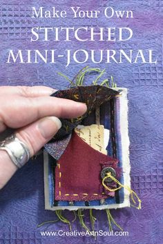 someone is stitching together fabric to make a mini - journal